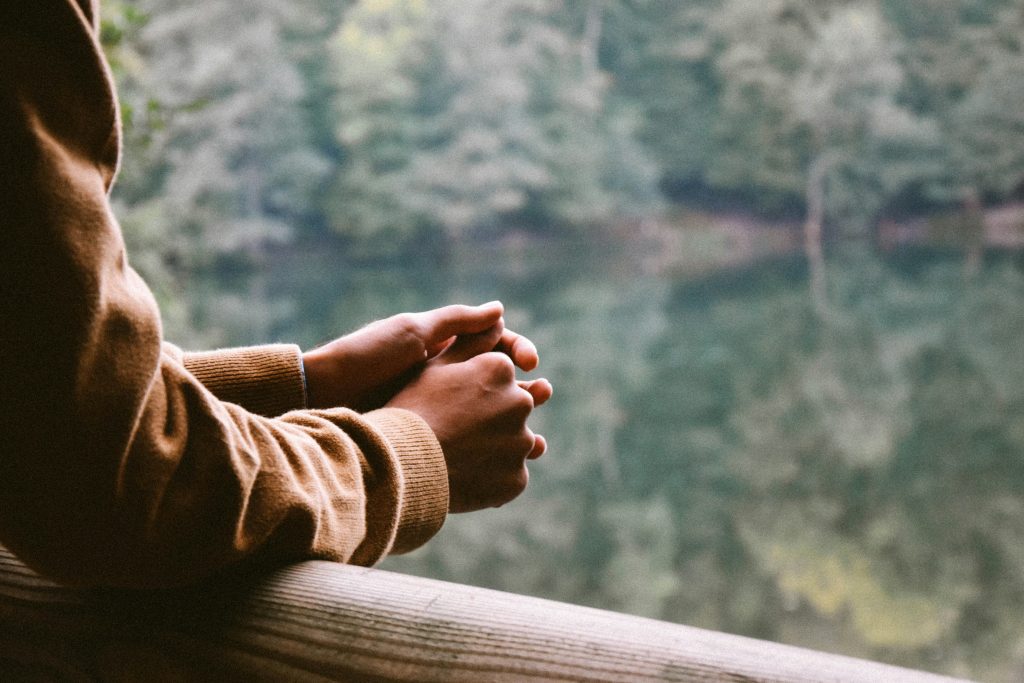 folded hands in pensive position